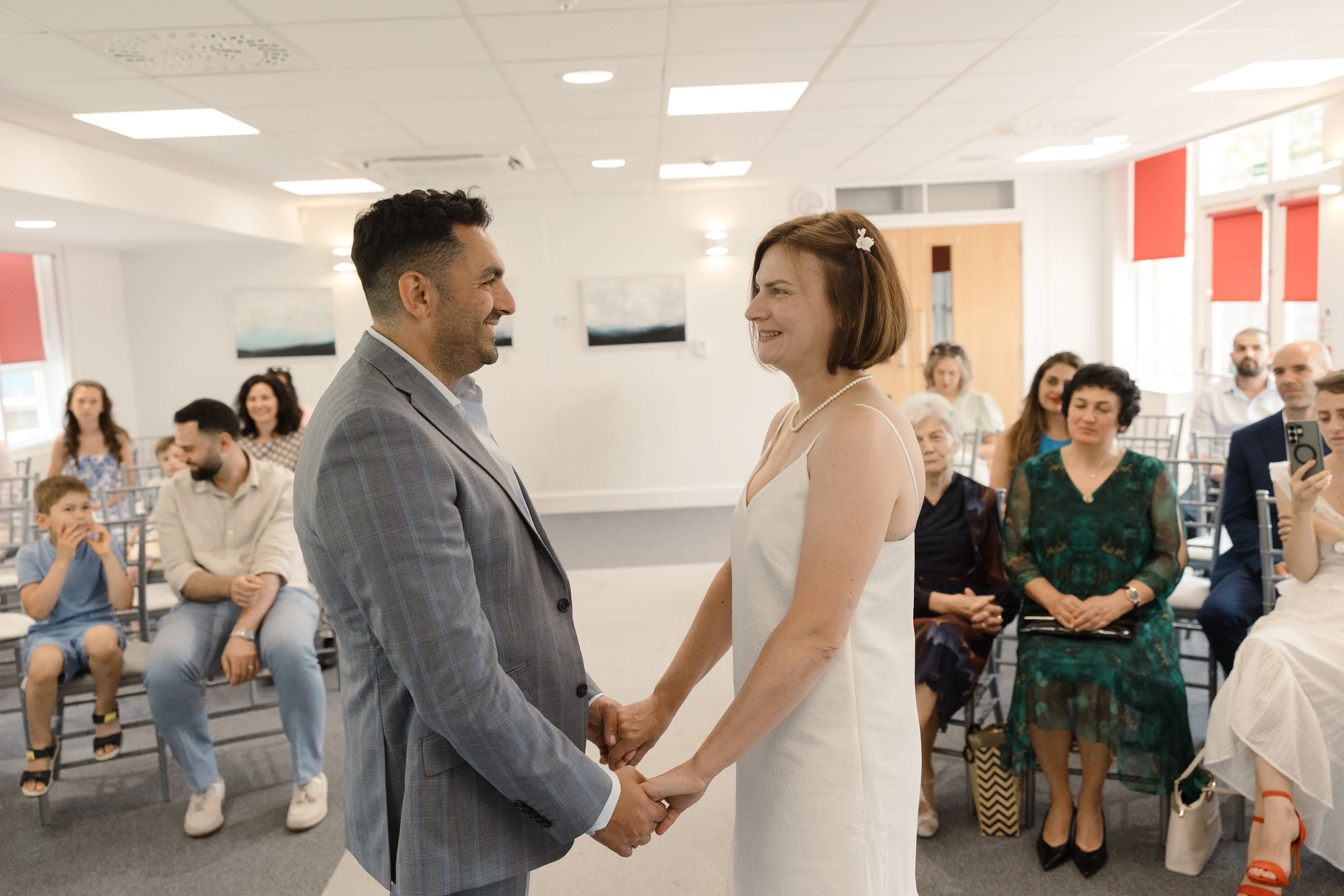 Holding hands during the vows &mdash; Zita and Aurelian
